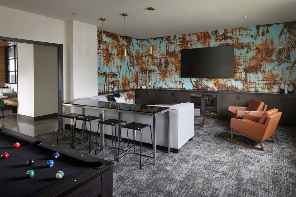 a room with a pool table and a bar