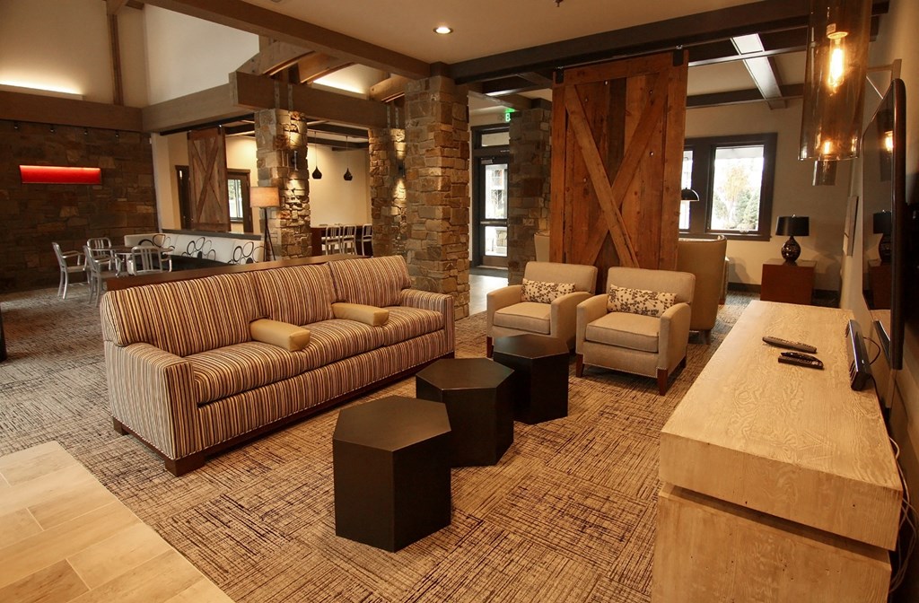 a living room with couches and chairs and a table