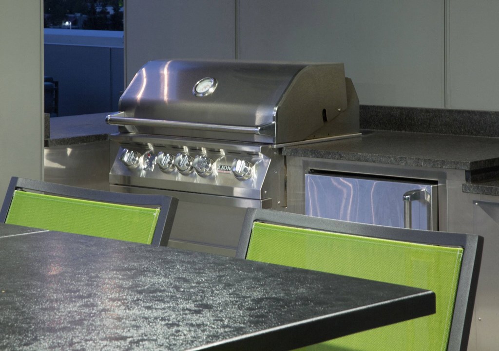 a kitchen with a stainless steel grill and counter tops