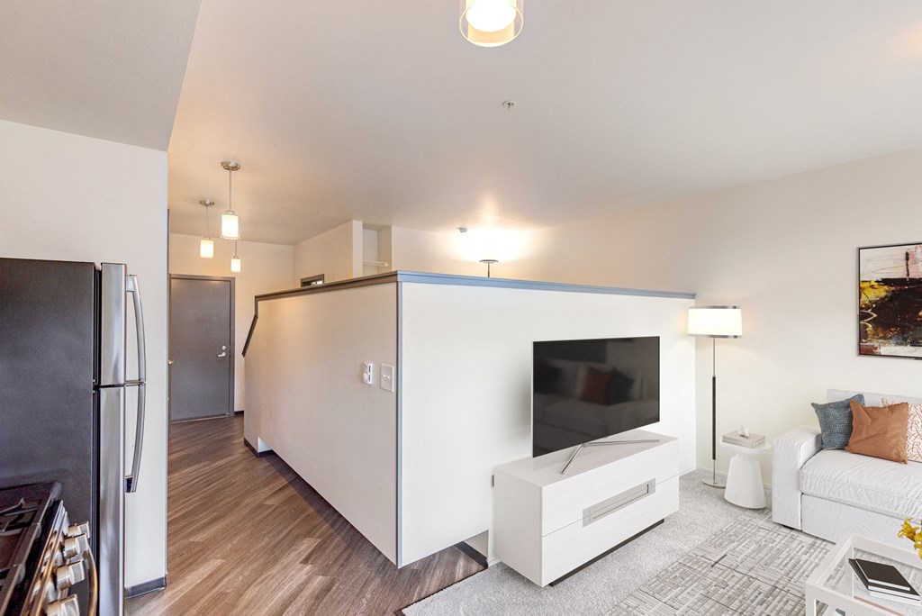 a living room with a white wall and a television