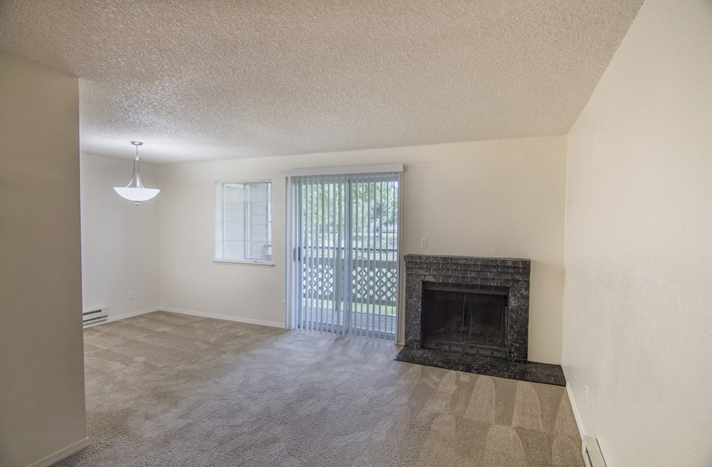 a living room with a fireplace and a patio door