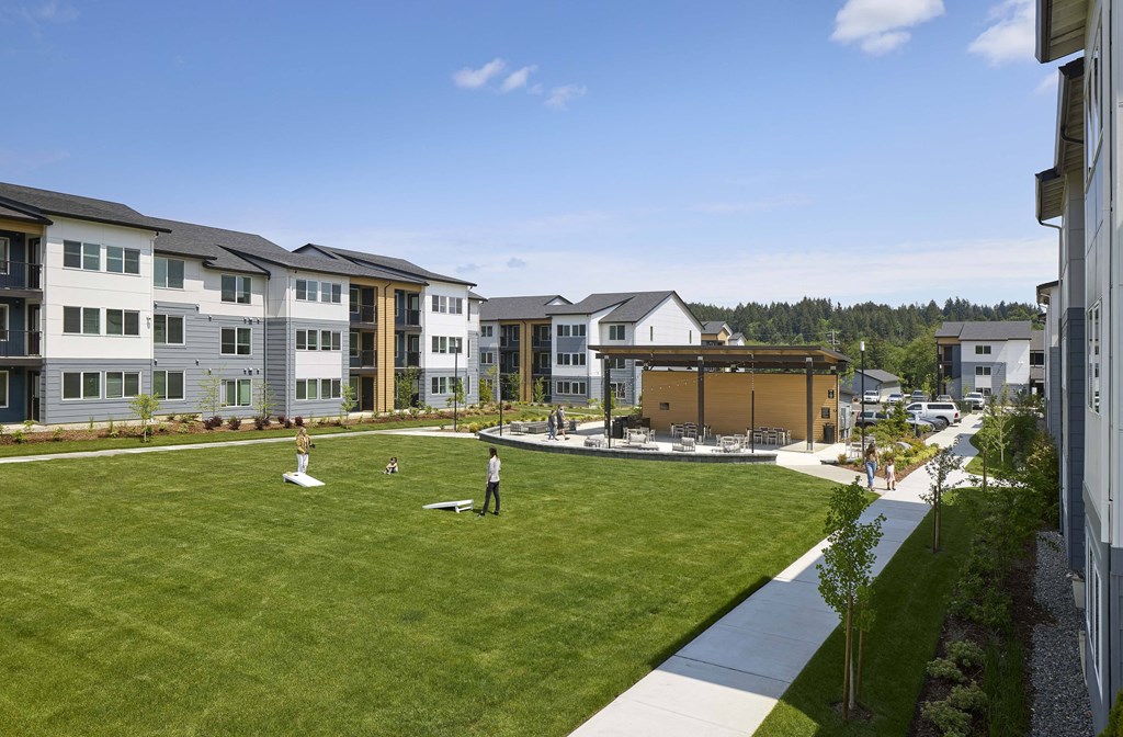 an aerial view of a grassy area with people playing frisbee