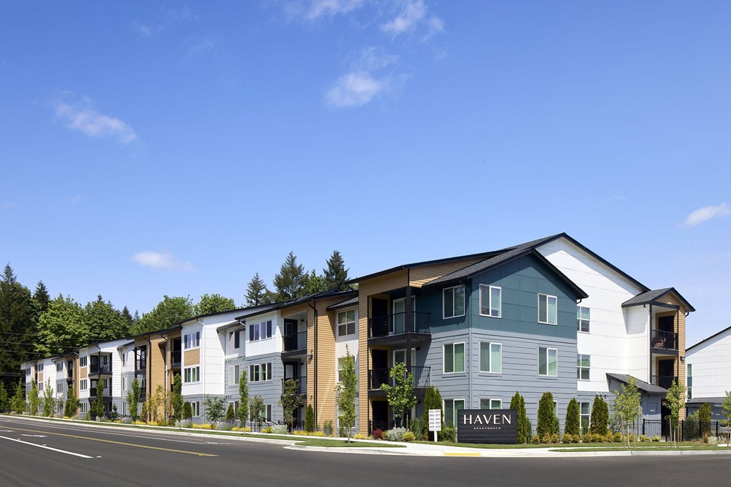 an image of a apartment building with a blue sky in the background