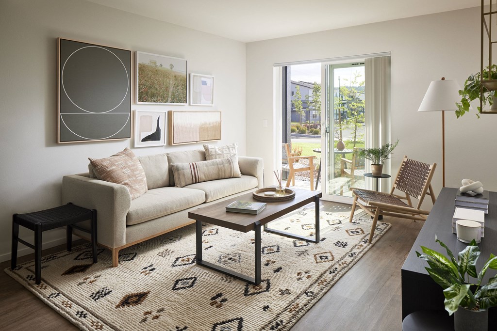 a living room with a white couch and a black and white rug