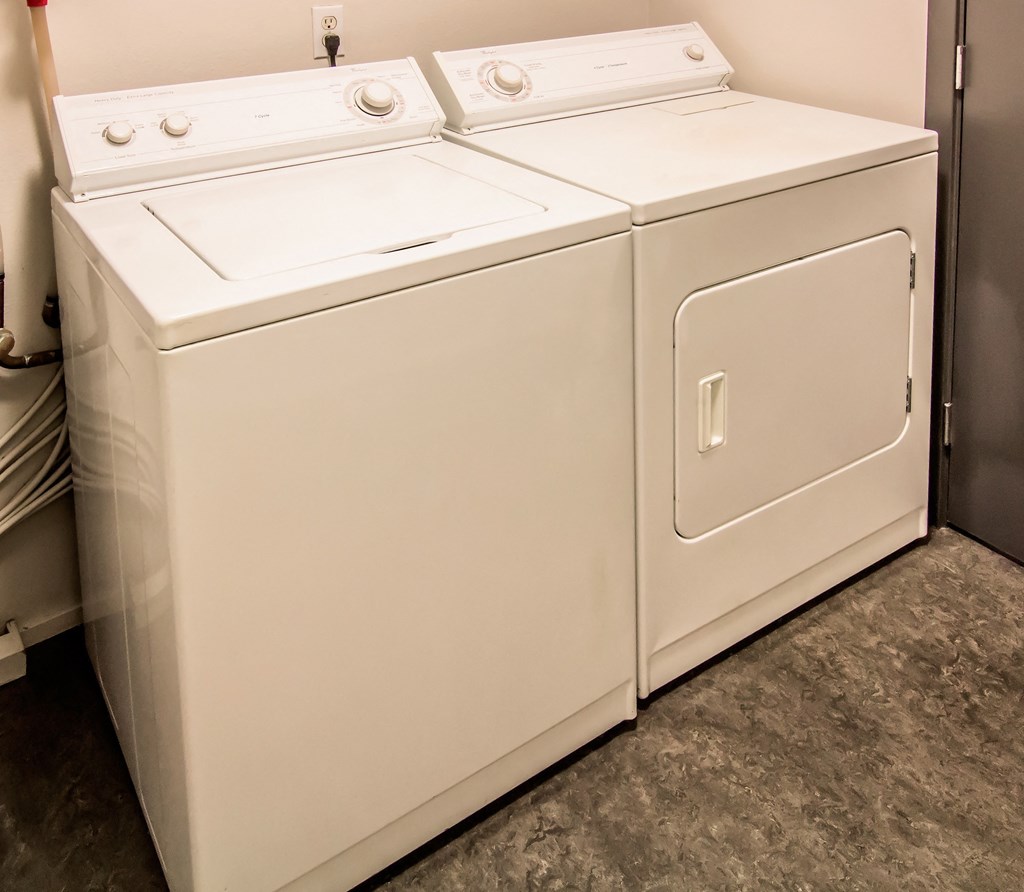 a white washer and dryer in a laundry room