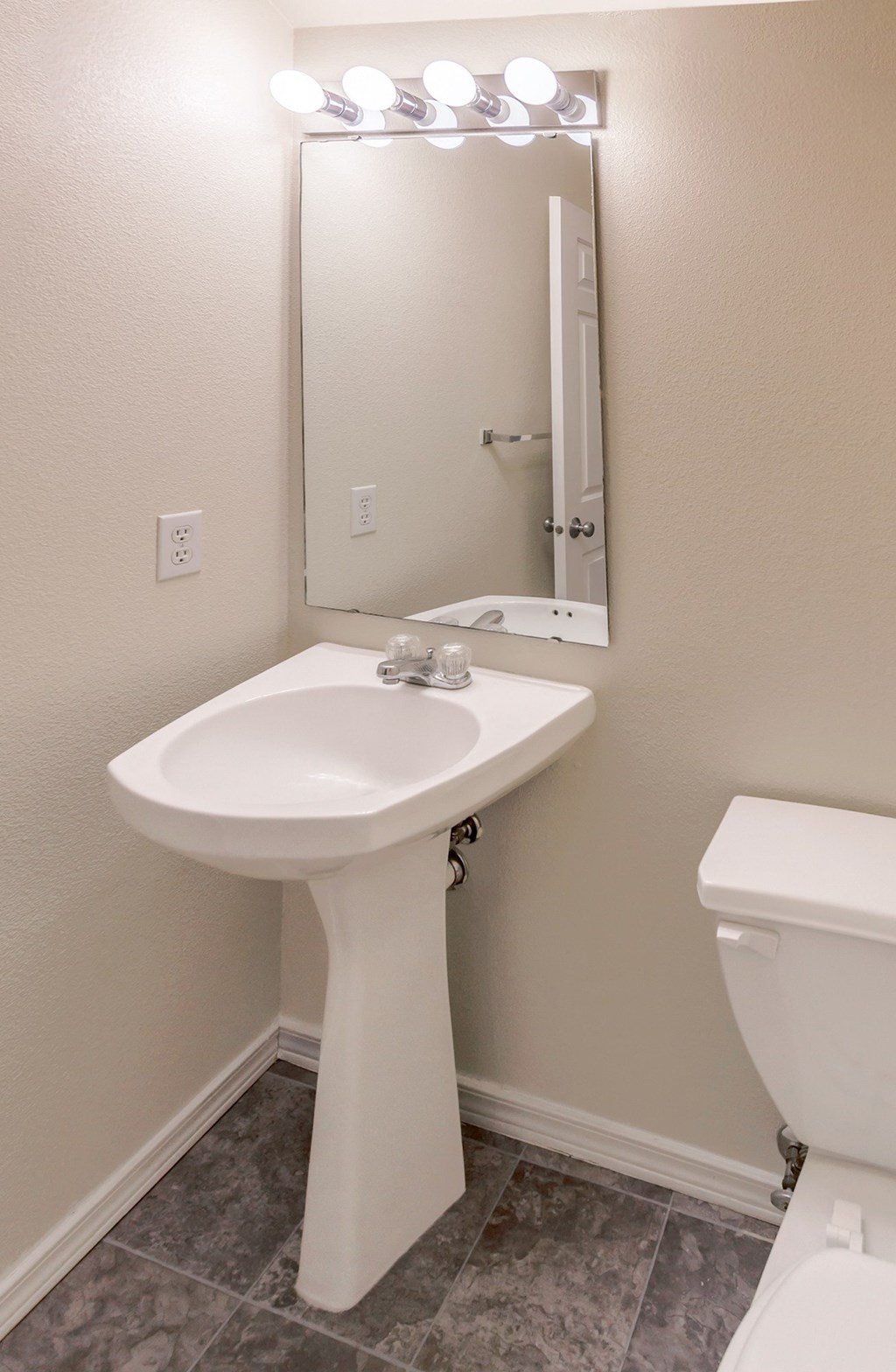 a bathroom with a sink and a mirror and a toilet