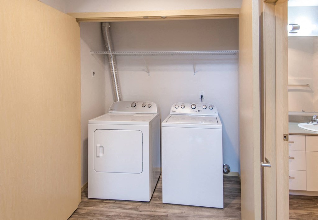 a room with two washes and a dryer in it