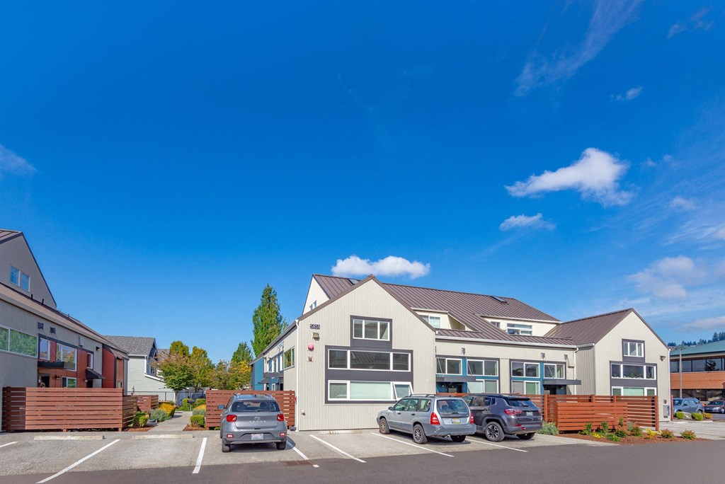 a parking lot with cars in front of a house