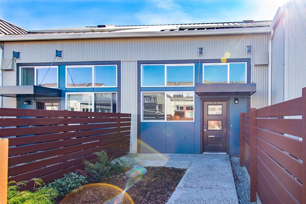the front of a building with glass windows and a door