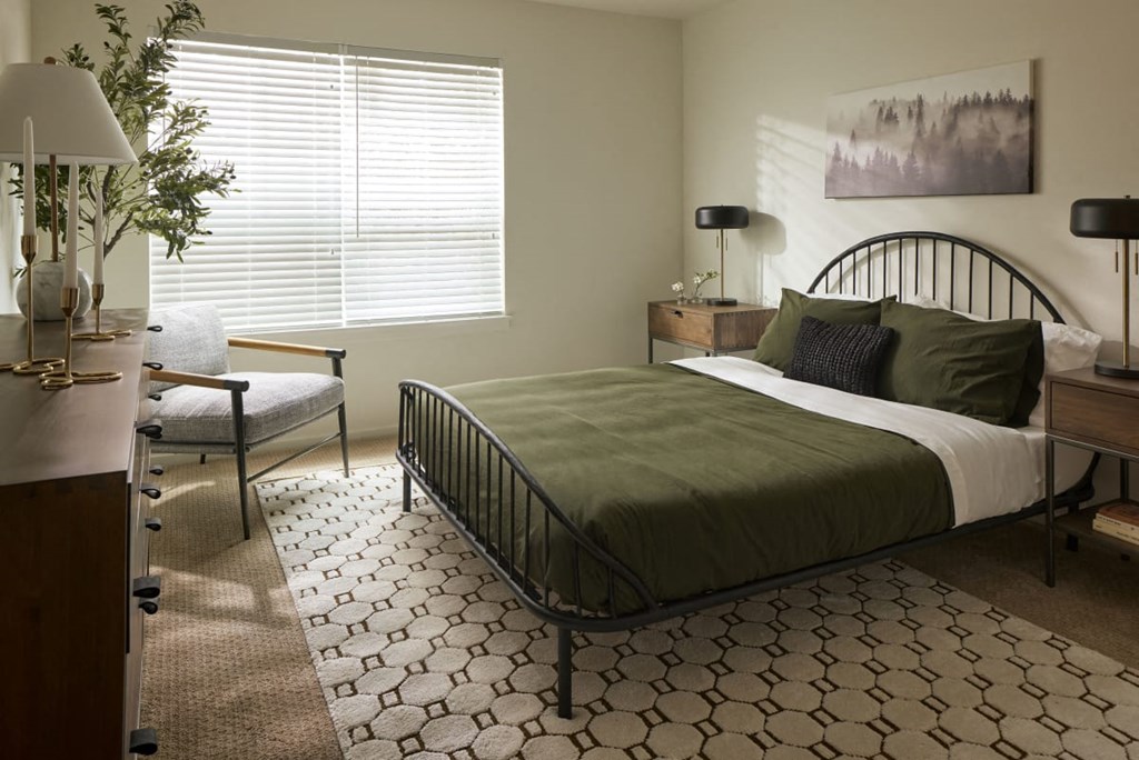 a bedroom with a bed and a chair