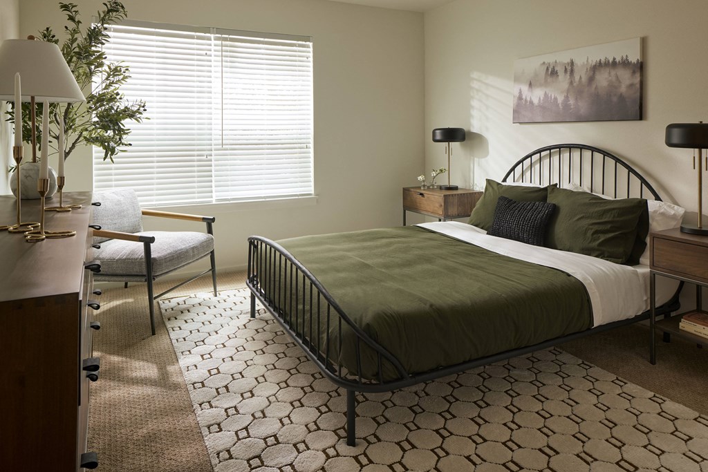 a bedroom with a bed and a chair