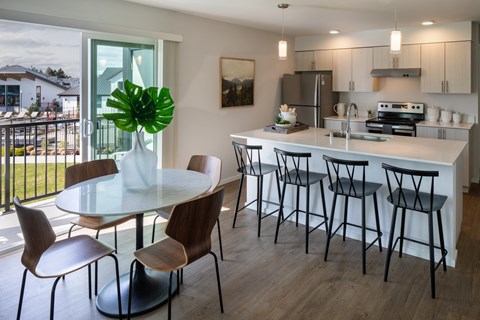 an open kitchen and dining area with a large table and chairs