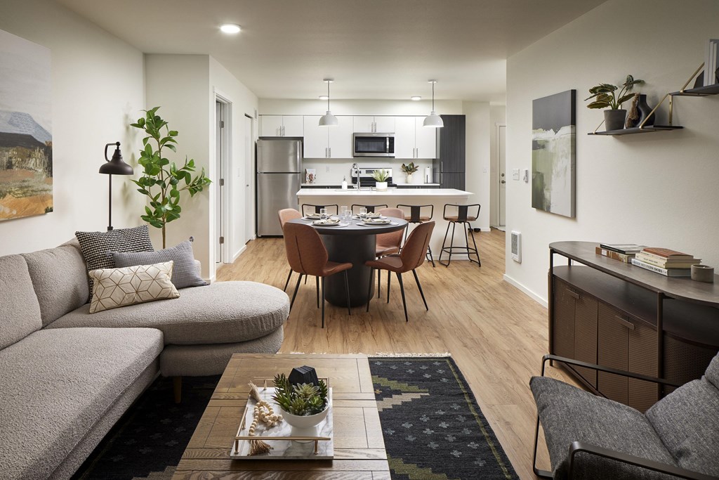 an open concept living room and kitchen with a dining room table and chairs