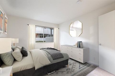 A bedroom with a bed, dresser, and mirror at The Woods Apartments, San Jose, CA, 95136