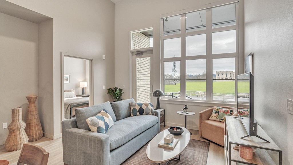 a living room with a couch and a large window