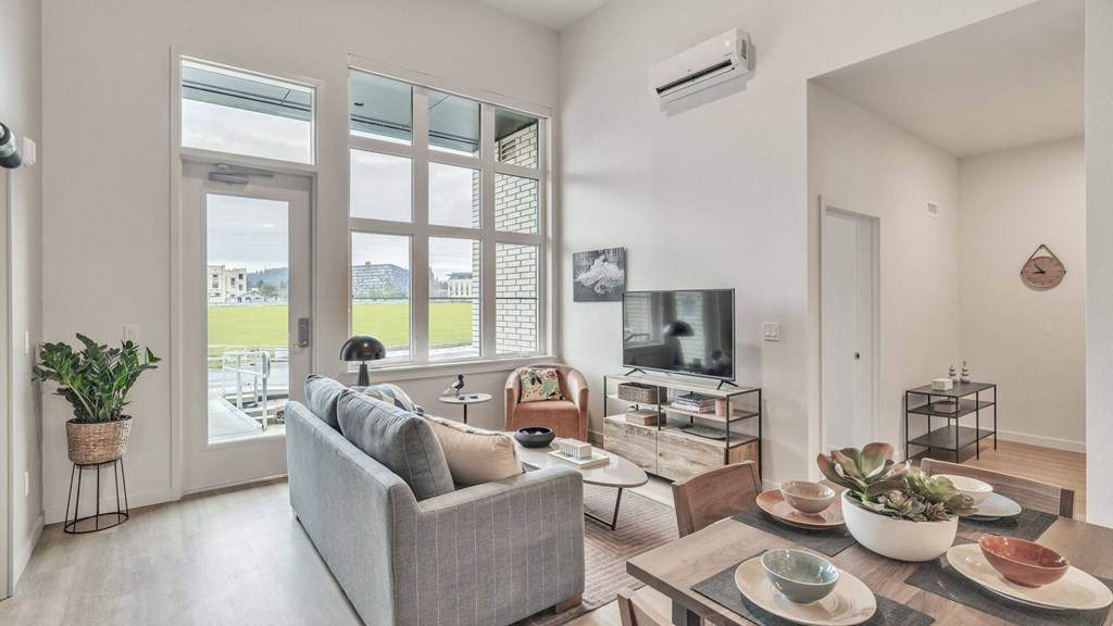 a living room with a couch and a table and a tv