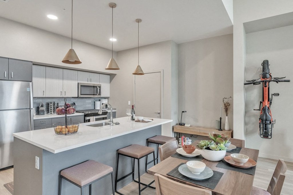 a kitchen and dining area with a table and chairs