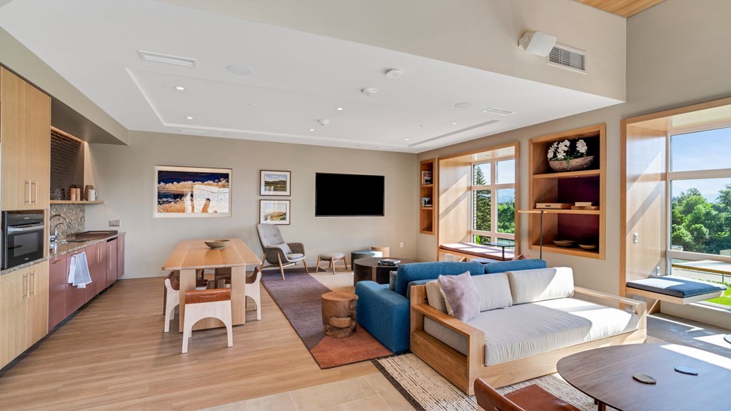 a living room with a blue couch and a wooden table