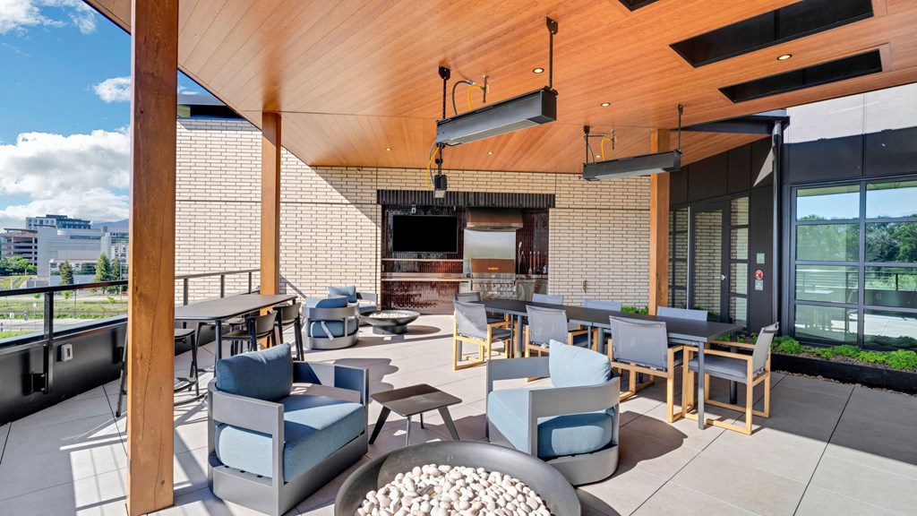a lounge area with chairs and tables and a television