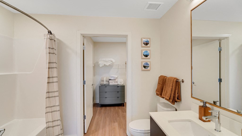 a bathroom with a shower and a sink and a toilet