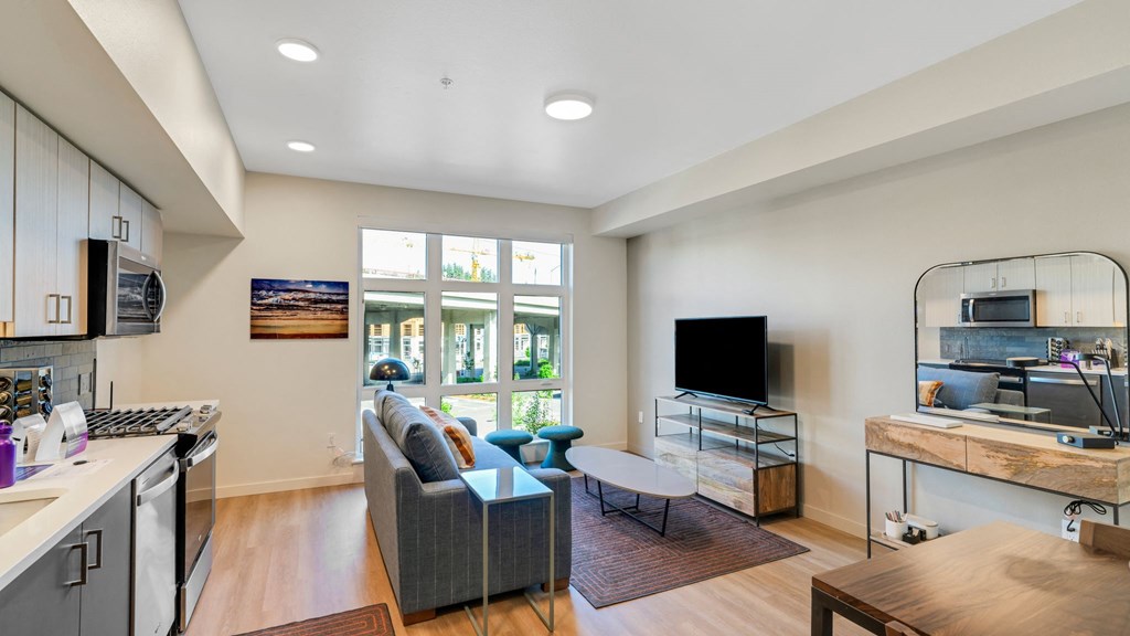 a living room with a couch and a table and a tv