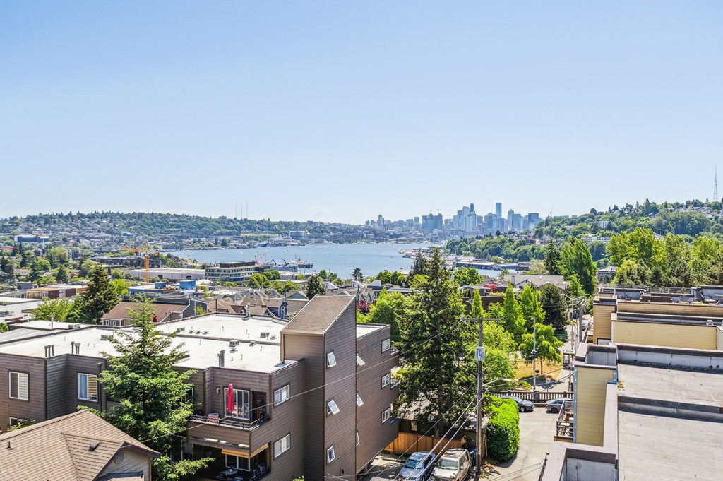 an aerial view of a building with a view of the city in the background