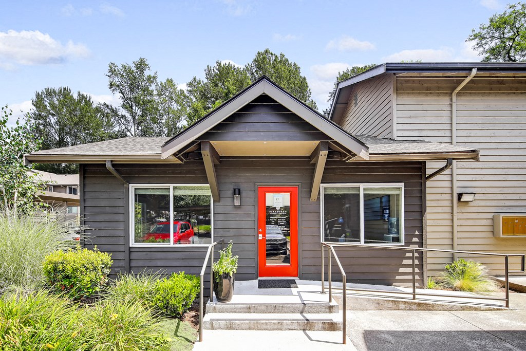 the front of a house with a red door