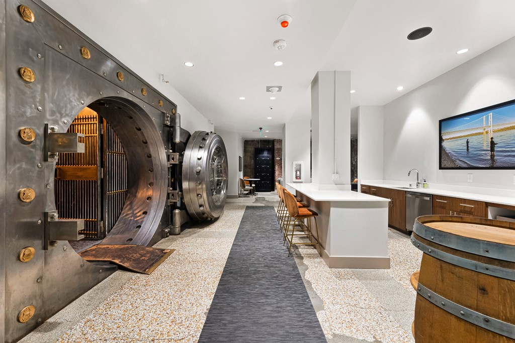 a large metal machine in a room with tables and chairs