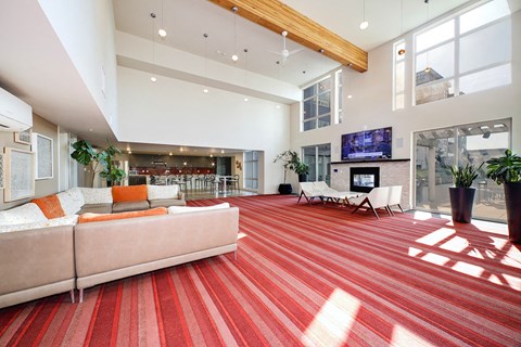 a large living room with a red carpet and a fireplace