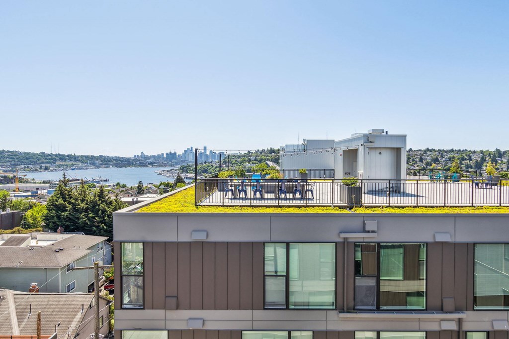 a rooftop terrace with a yellow roof and a view of the city