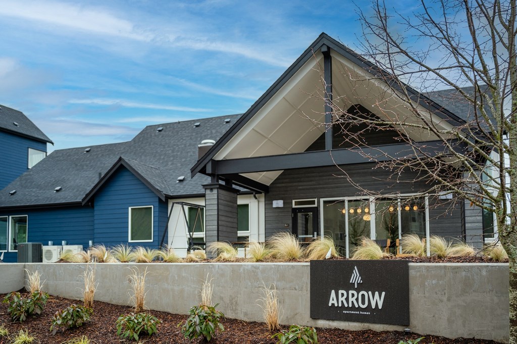 a home with a gray roof and blue walls