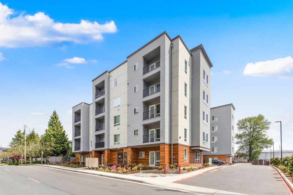 a picture of an apartment building with a blue sky in the background