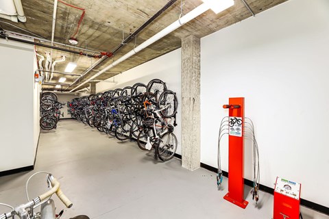 a long row of bikes parked in a room