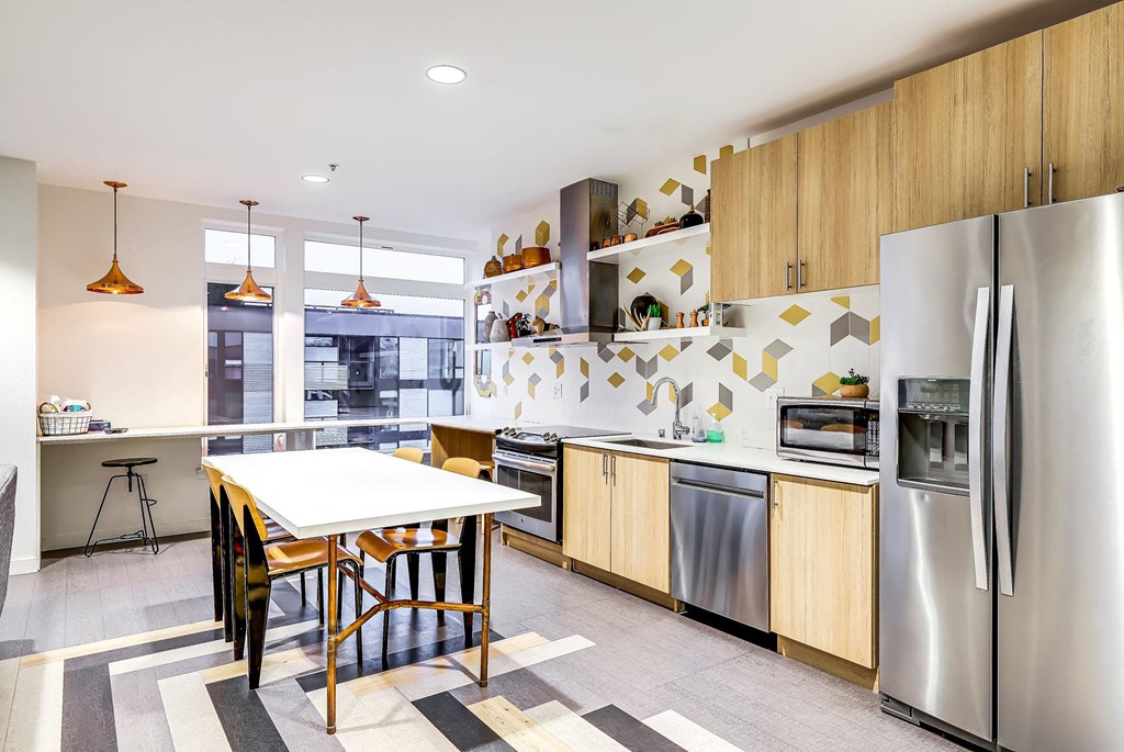 A modern kitchen with a dining table and chairs.
