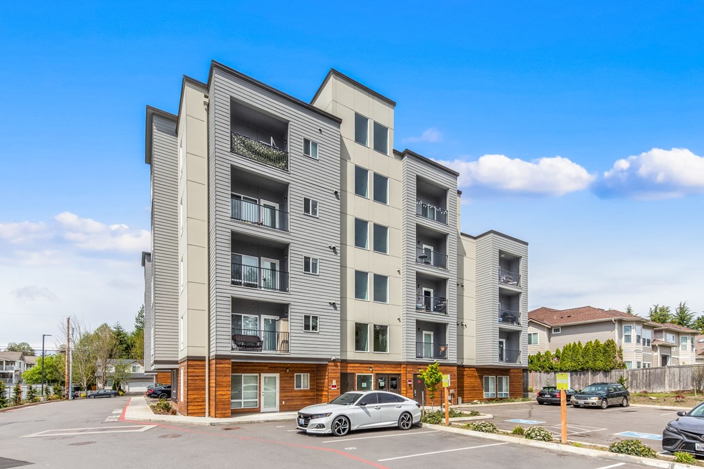 a picture of an apartment building with a car parked in front of it