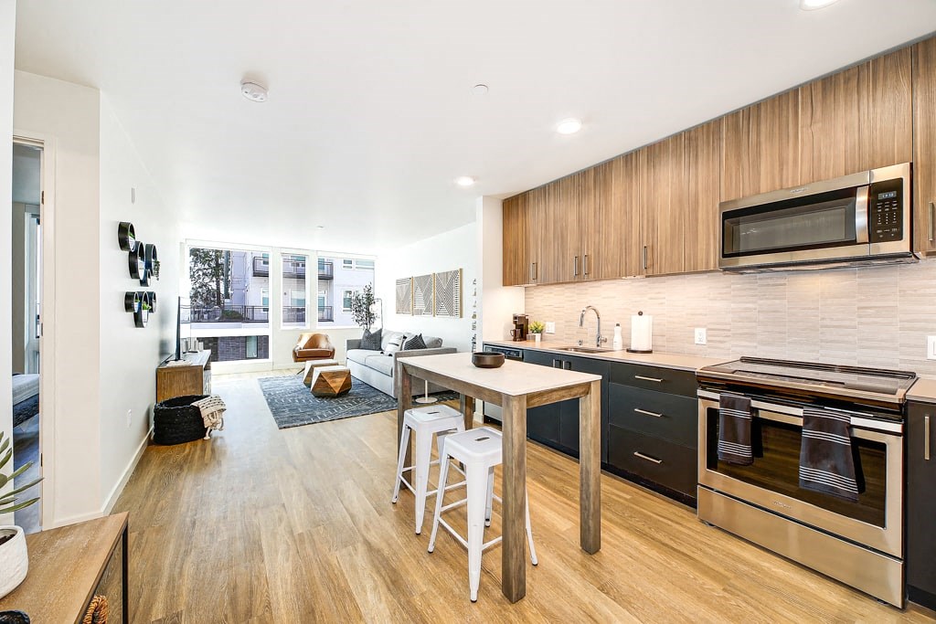 a kitchen and living room with a table