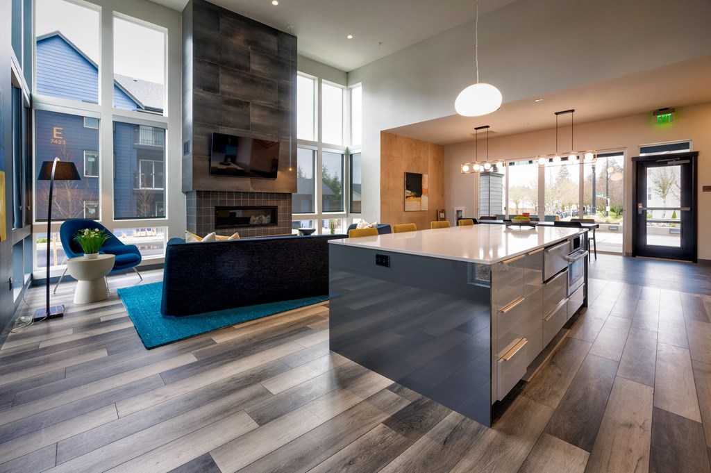 a kitchen with a large island in front of a fireplace