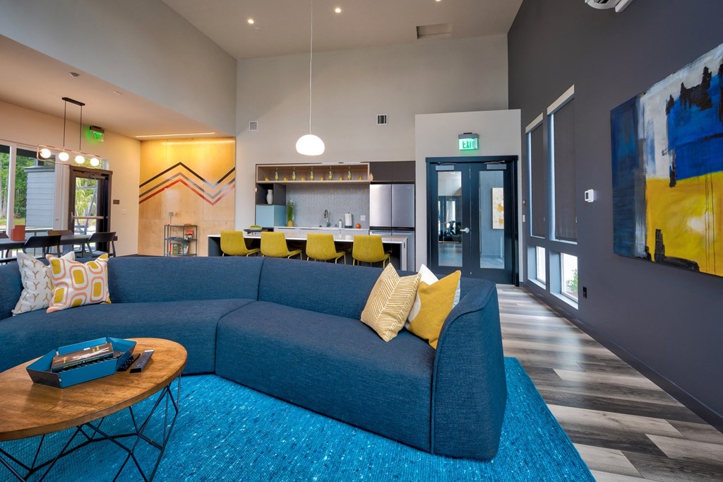 a living room filled with furniture and a large window