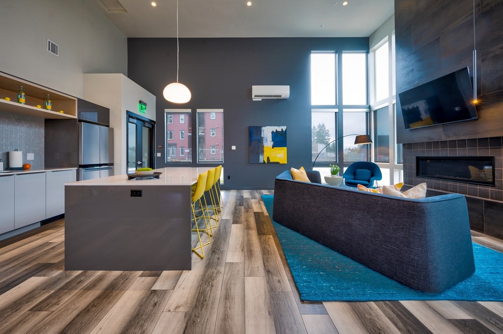 a kitchen and living room with a fireplace and a large window