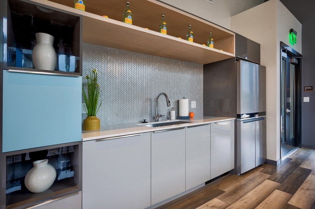 a kitchen with white cabinets and a wooden floor