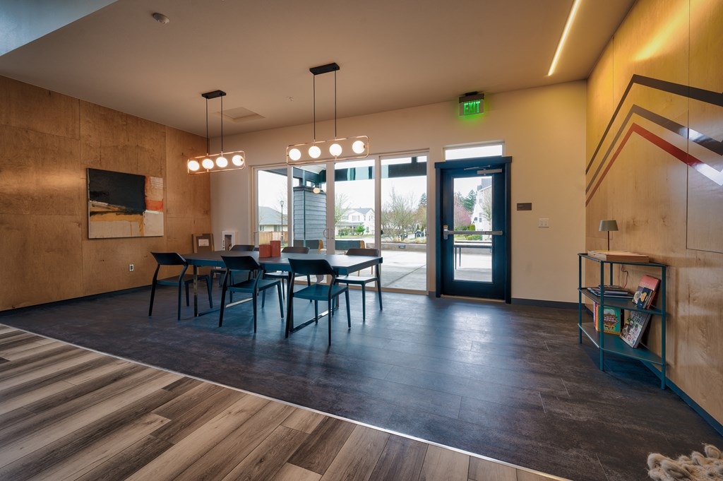 a dining room with a table and chairs in front of a glass door