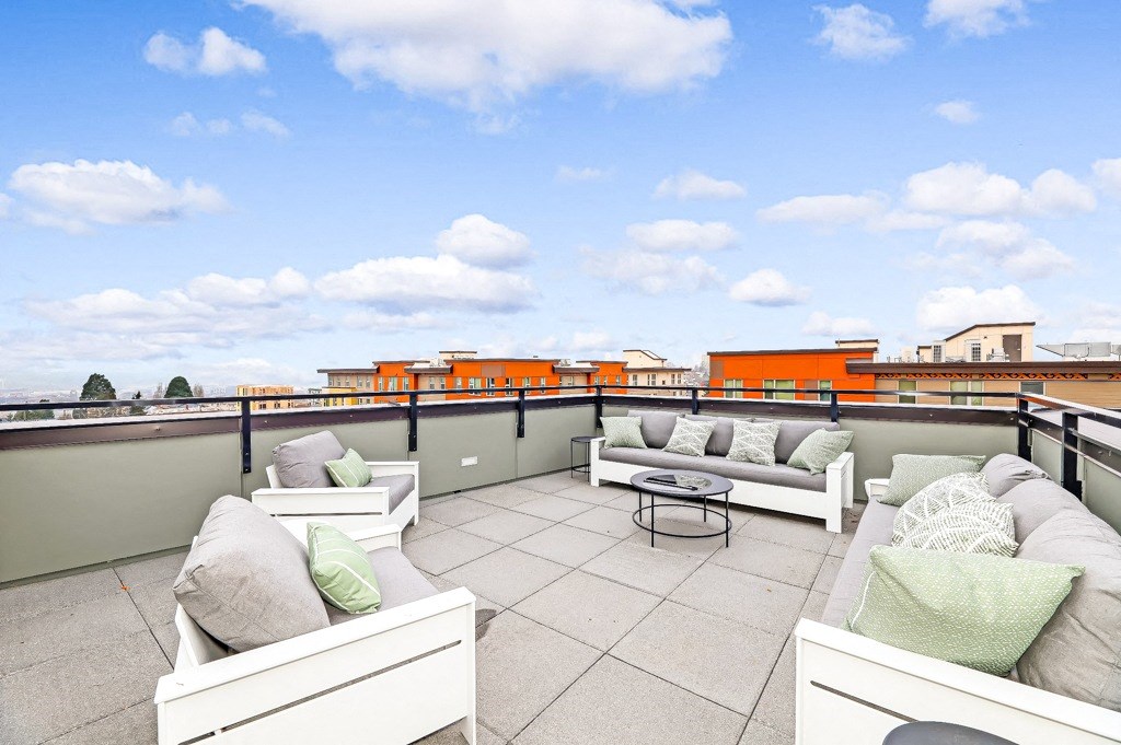 a rooftop terrace with couches and a table