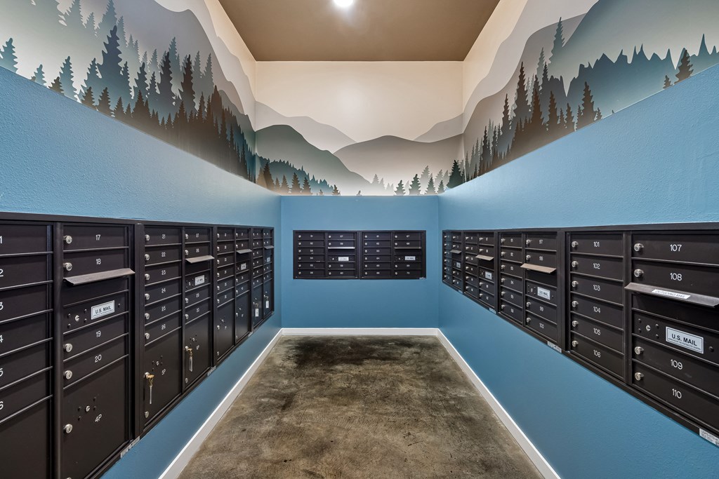a view of the mail room with a mountain mural on the wall
