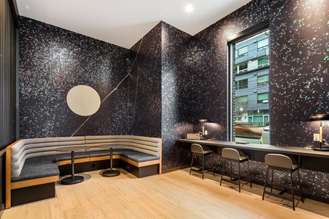 a room with a bench and a table and a window