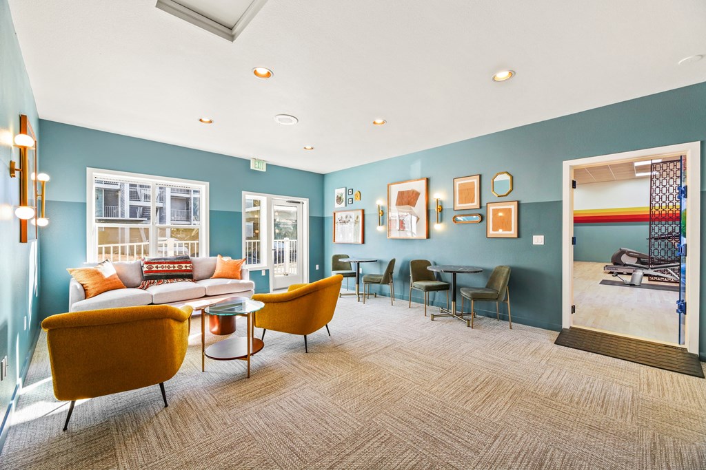 a living room with blue walls and a couch and chairs