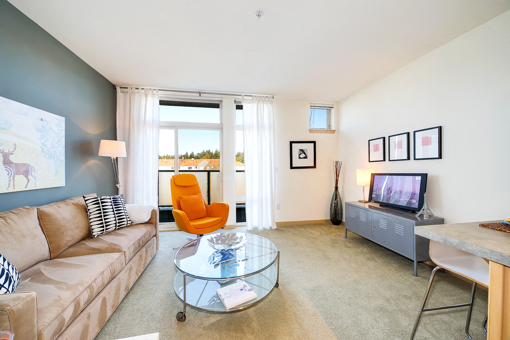 a living room with a couch and a table and a tv