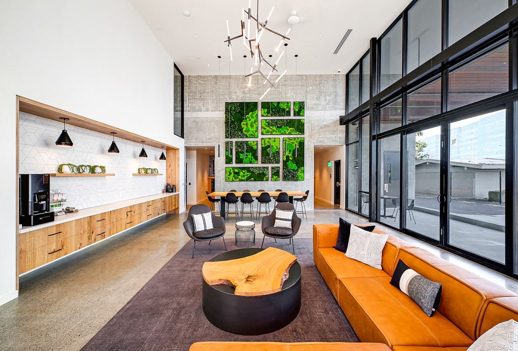 a living room with an orange couch and a table with chairs