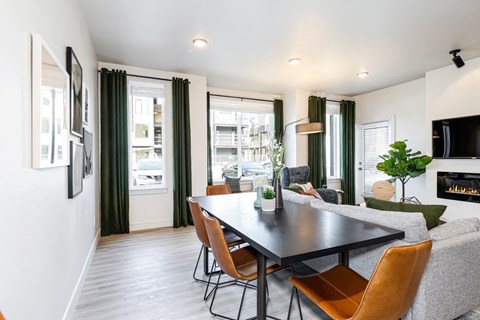 a living room with a table and chairs and a fireplace