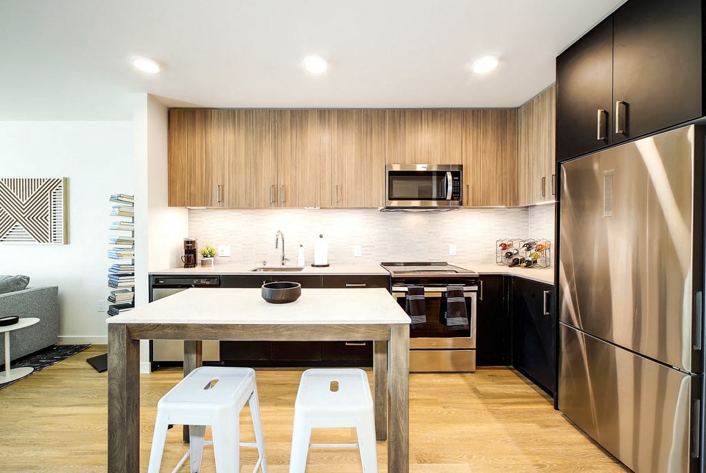 a kitchen with a table and two stools