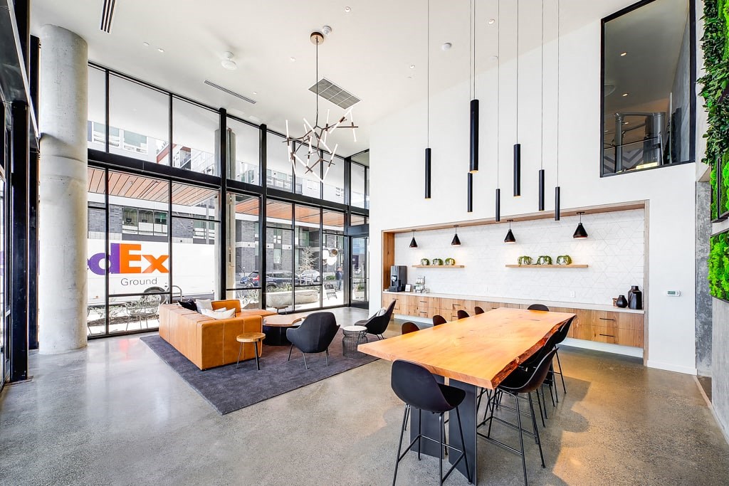 a large dining room with a wooden table and chairs